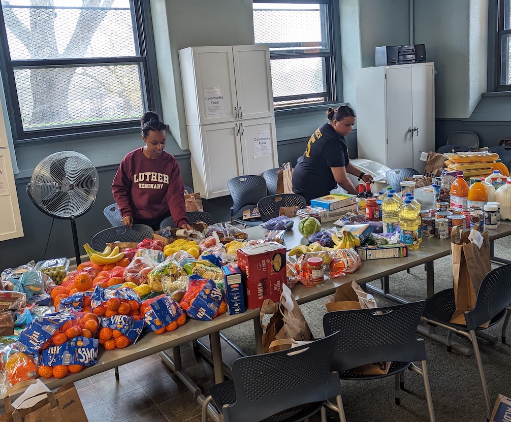 Ruth Ibrahim (left) and Alyssa Saleem organizing food items for the grocery assistance program.