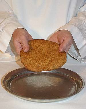 Pastor holding communion bread