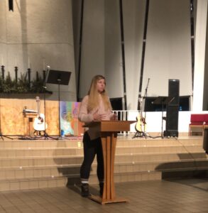 Luther Seminary graduate Grace Zauche preaches during a worship service in a sanctuary