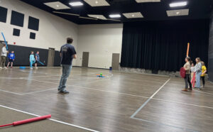 Luther Seminary graduate Phil Silva in a gymnasium helping to lead games for a church youth group