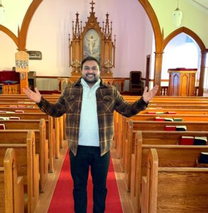Ehtisham Vicky, student at Luther Seminary, Saint Paul, in a church sanctuary.